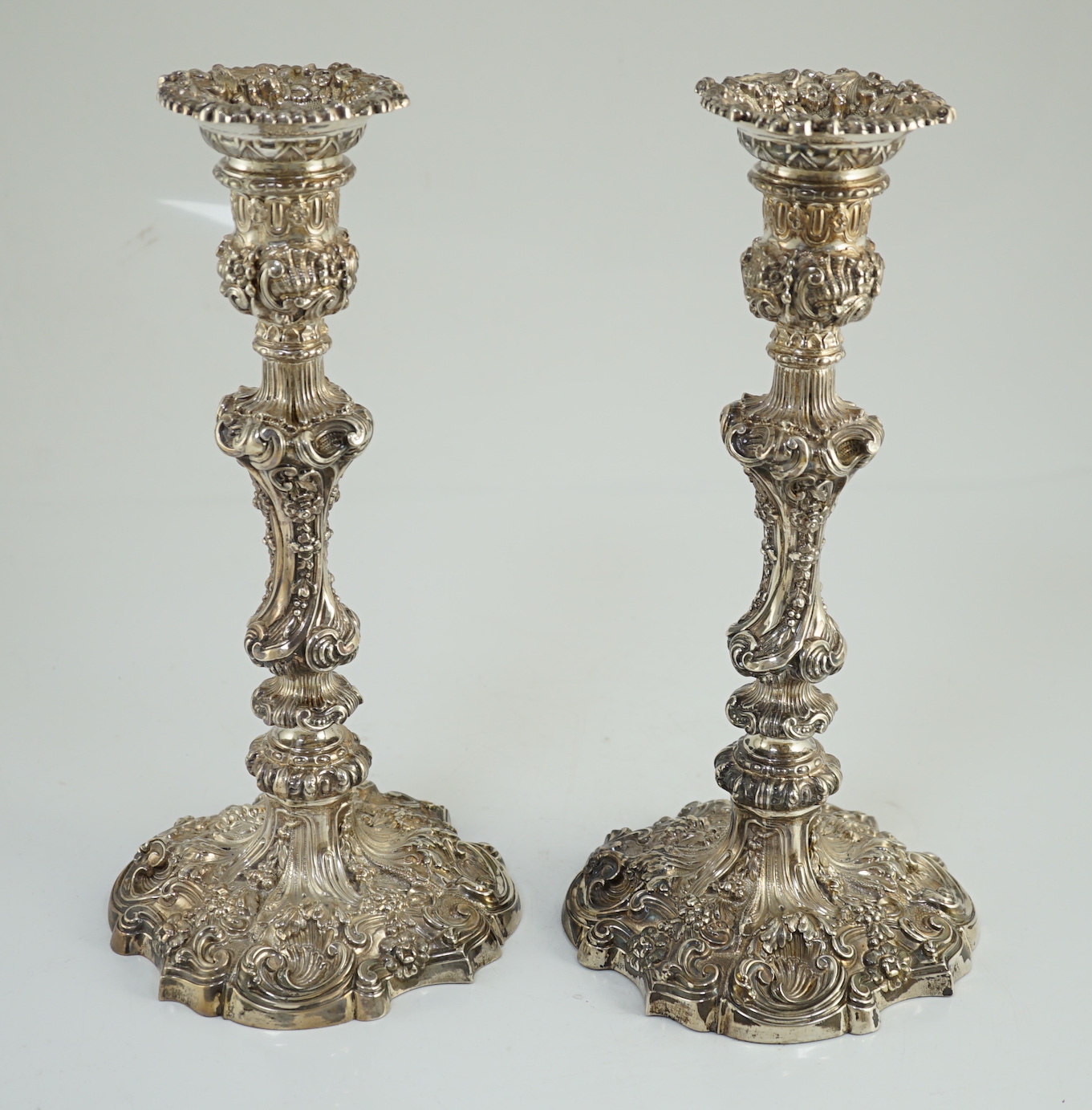 An ornate pair of Edwardian silver candlesticks, by Walker & Hall